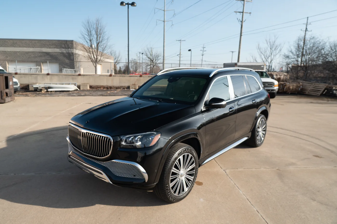 A black Mercedes-Maybach GLS with deep gloss paint, front three-quarter view