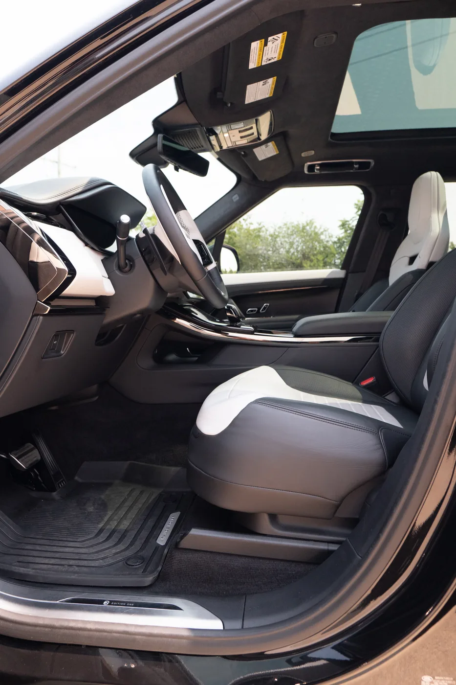 White and black leather seats in a Range Rover Sport, seen through the open door