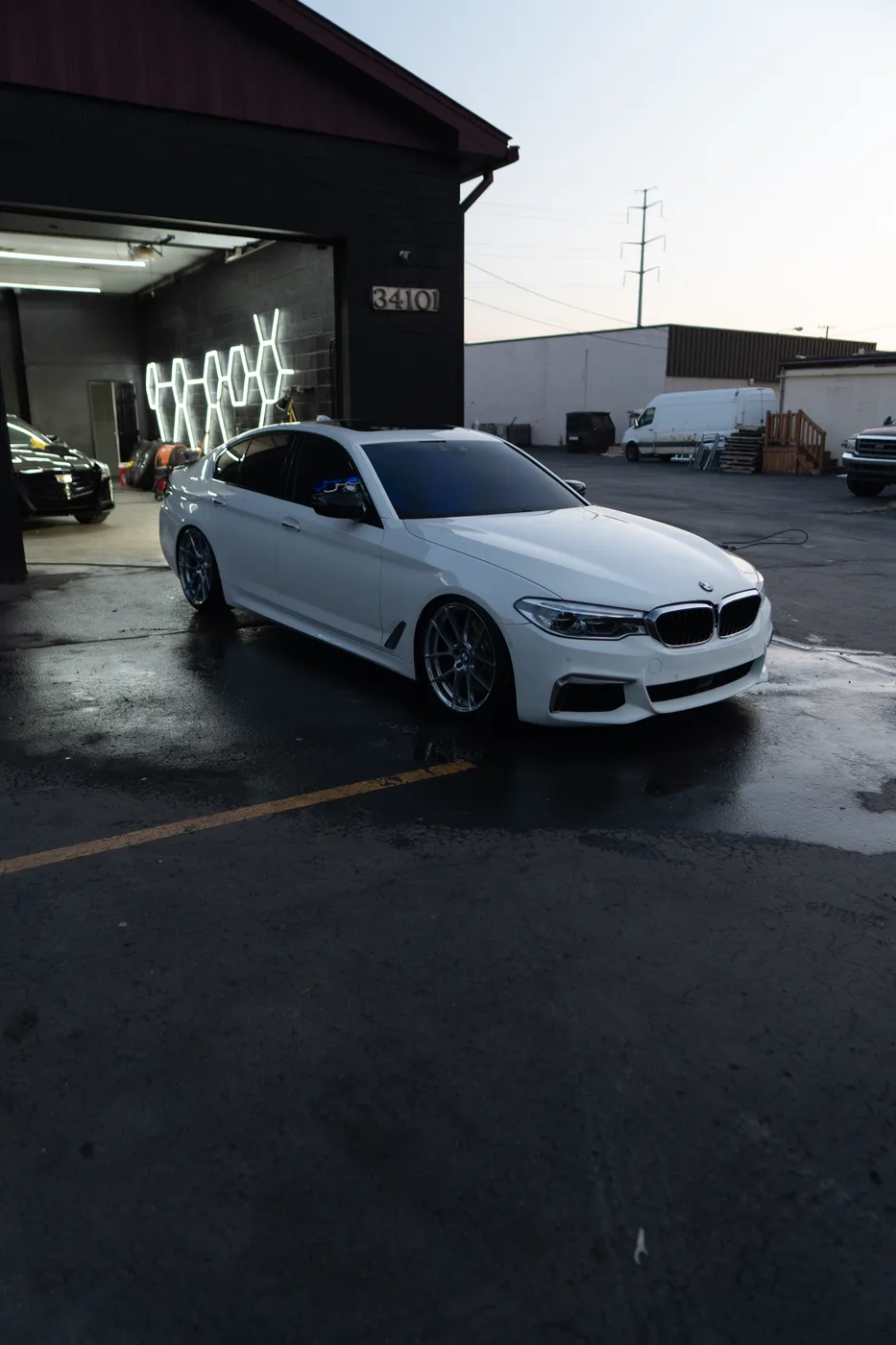 A white BMW 5 Series outside the Get Detailed MI shop