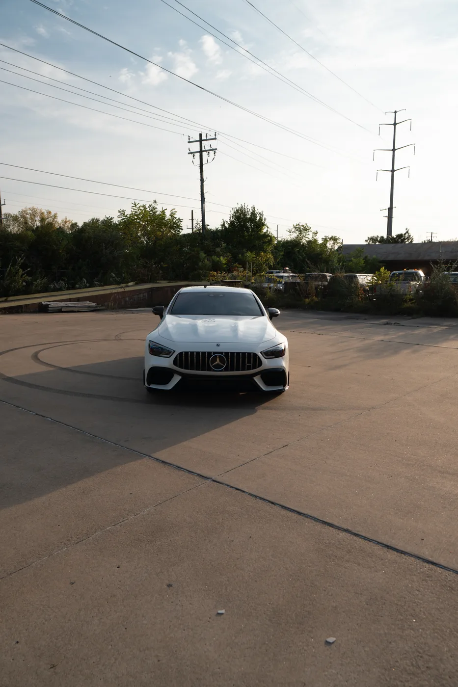 A white Mercedes-AMG GT four-door coupe, front view