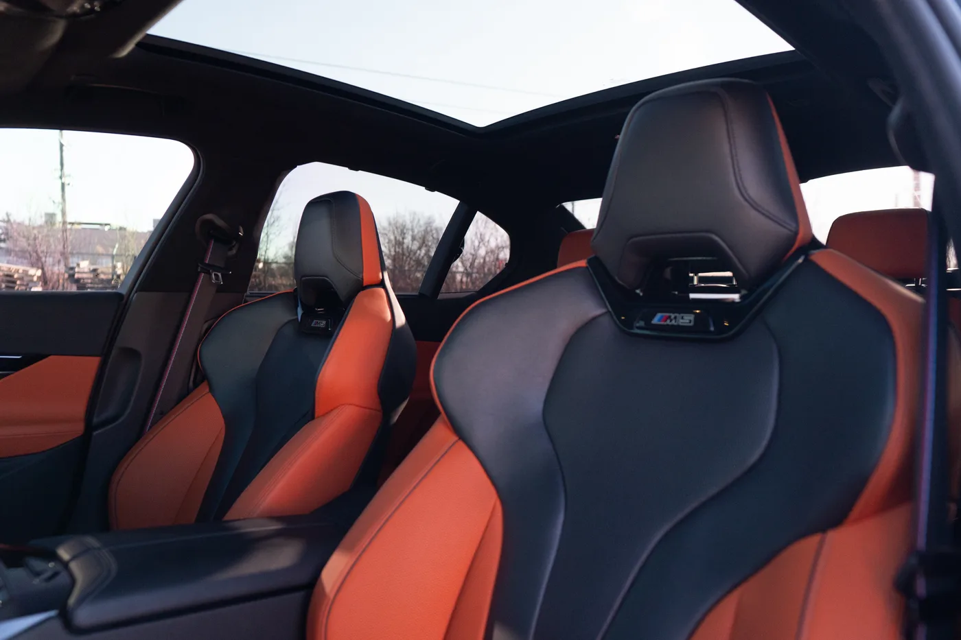 Orange and black leather sport seats in a BMW M5