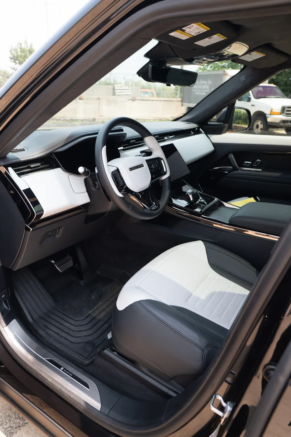 A Range Rover Sport cabin seen through the open driver door