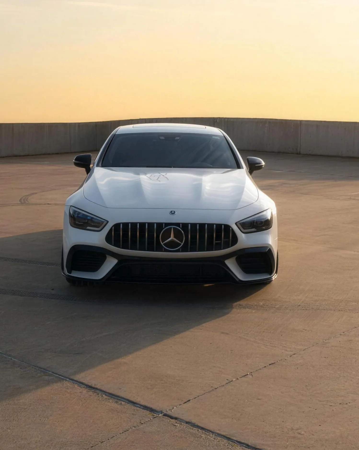 A white Mercedes-AMG GT at golden hour after detailing