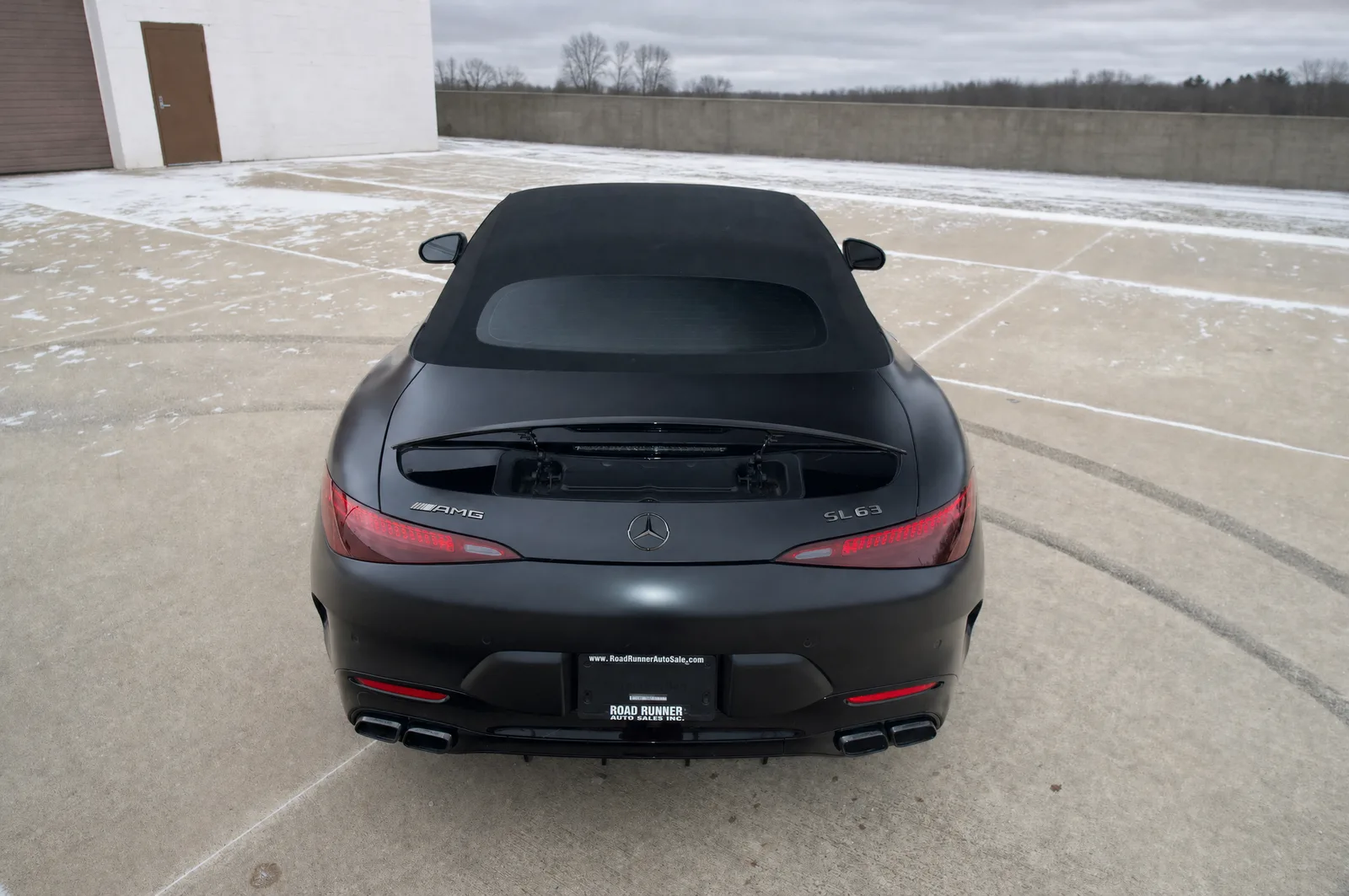 The rear of a matte black Mercedes-AMG GT after detailing